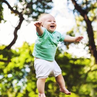 laughing baby floating on air